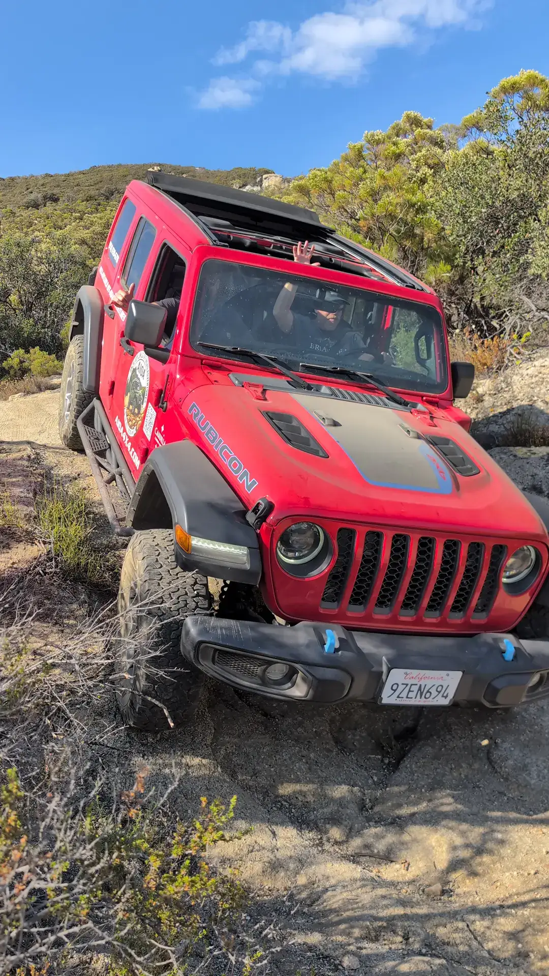 Red Rubicon Jeep crawling over granite on the Cahuilla trail