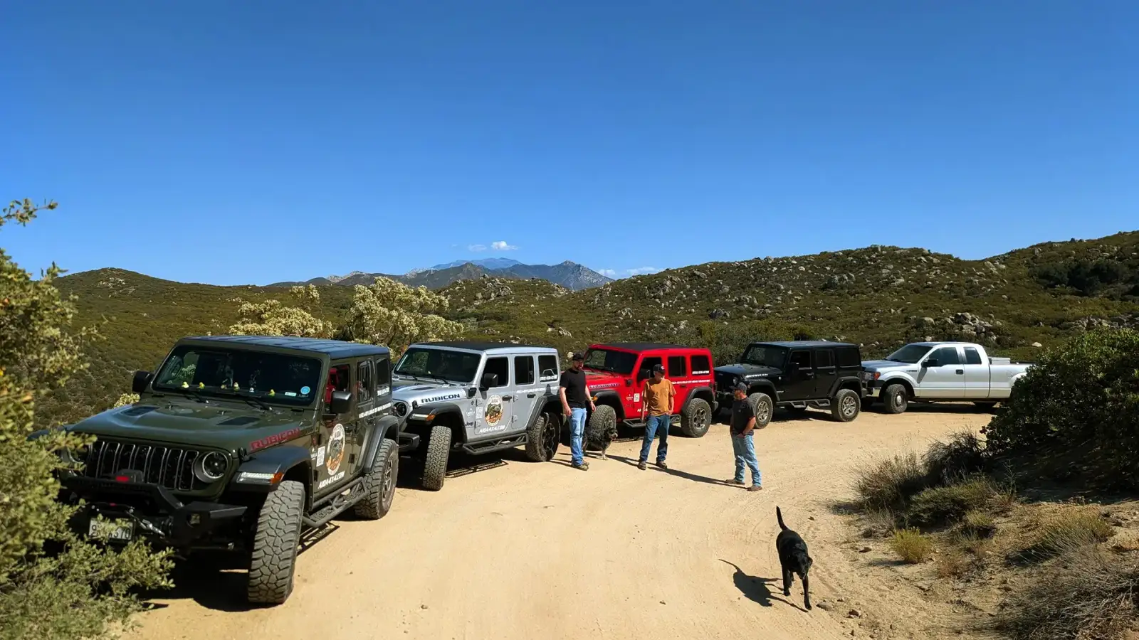 Full AIOA fleet staged on the dirt trail with San Jacinto Peak in the distance